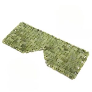 Masque yeux en jade naturel JadeZen ™ posé sur un plan.